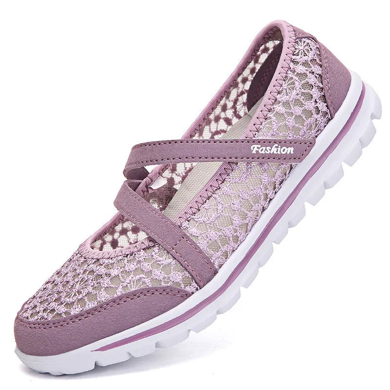 Women's beige lace-up flat casual shoes with mesh upper and sewing line detail on a white background.