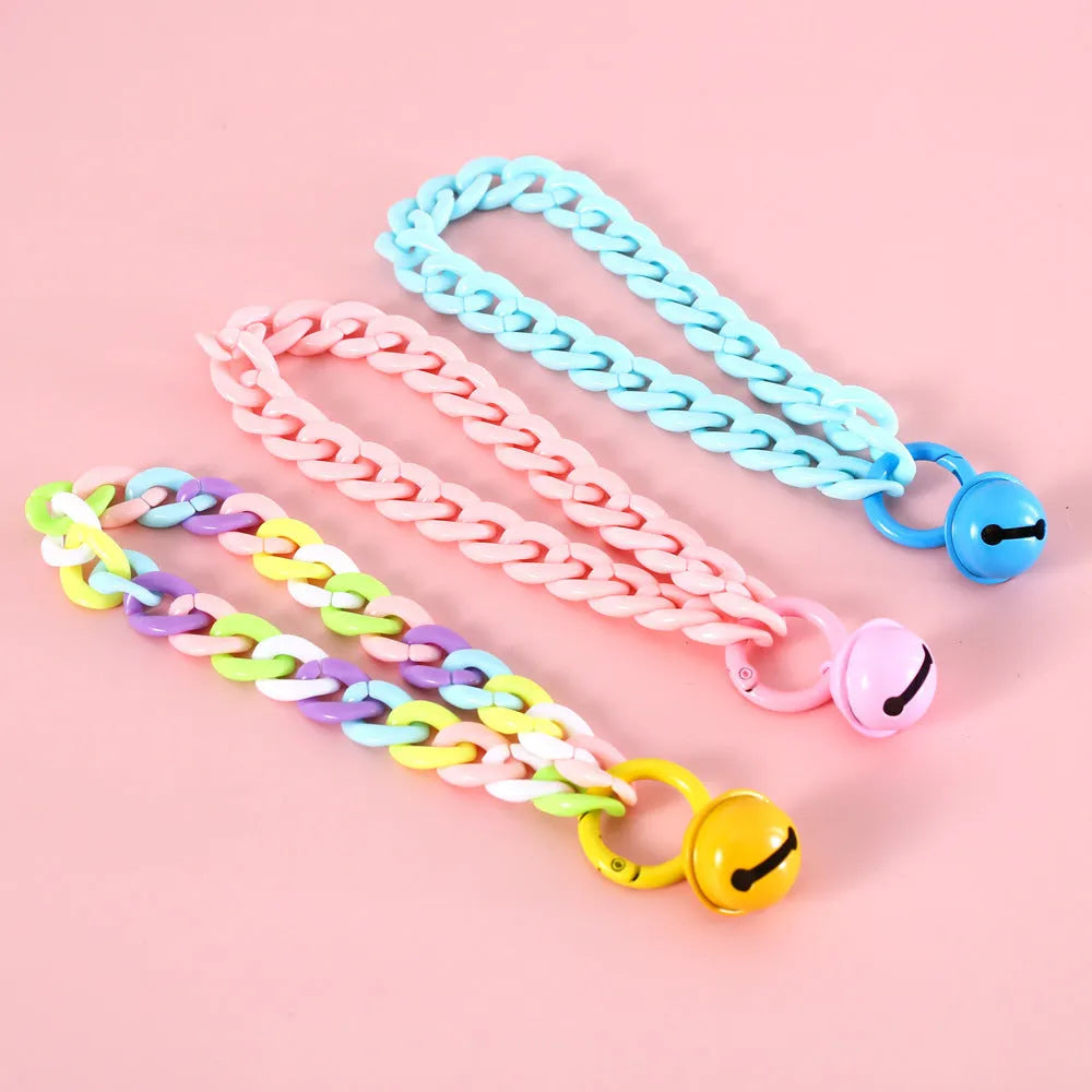 Adjustable plastic pet collar in macaron candy colours on a white background.