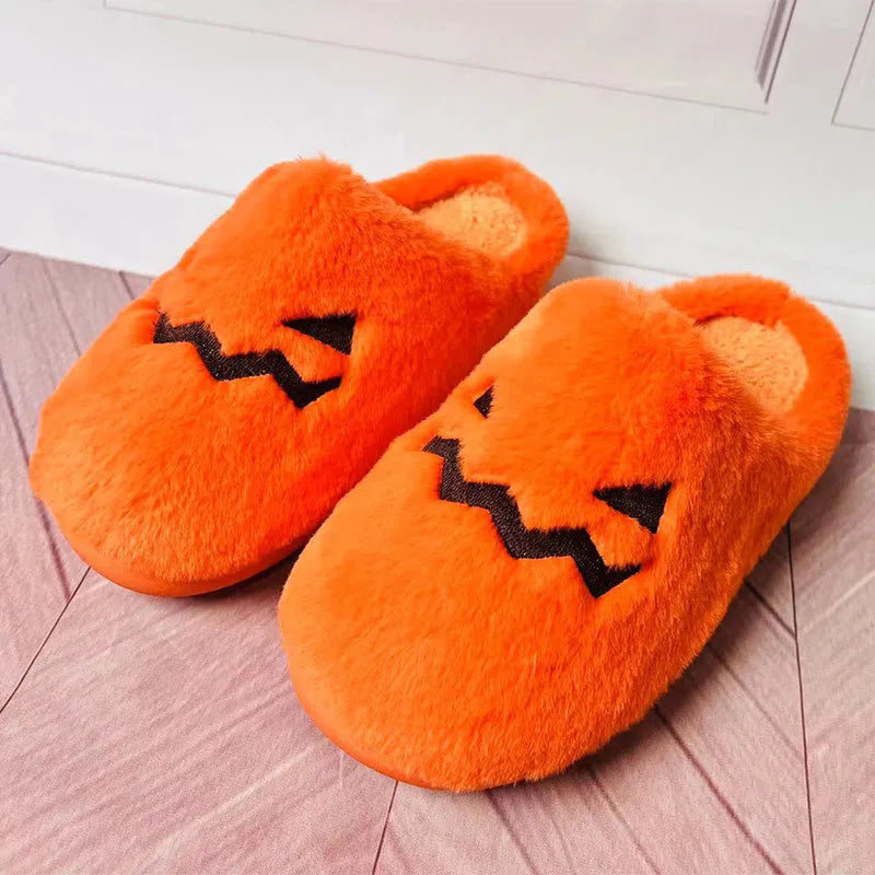 Orange Halloween pumpkin design plush slippers with a non-slip sole.