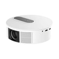 White HD home cinema projector with remote control on a wooden surface.