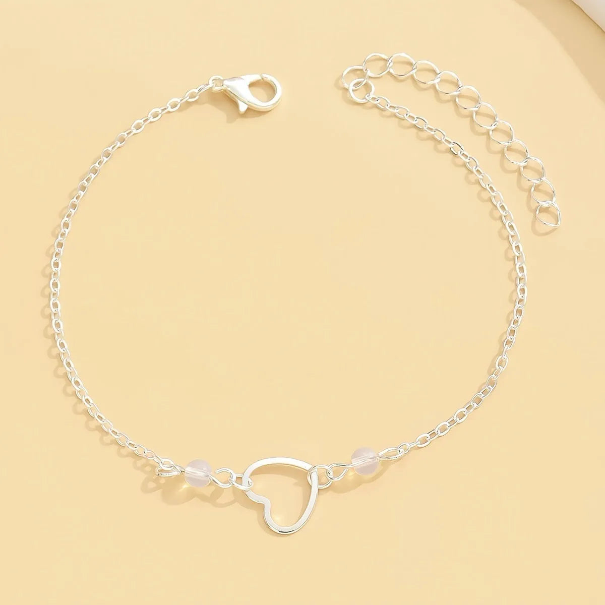 Gold and silver adjustable anklet with heart pendant and geometric chain