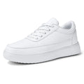 Women's white leather lace-up flat casual shoes on a neutral background.