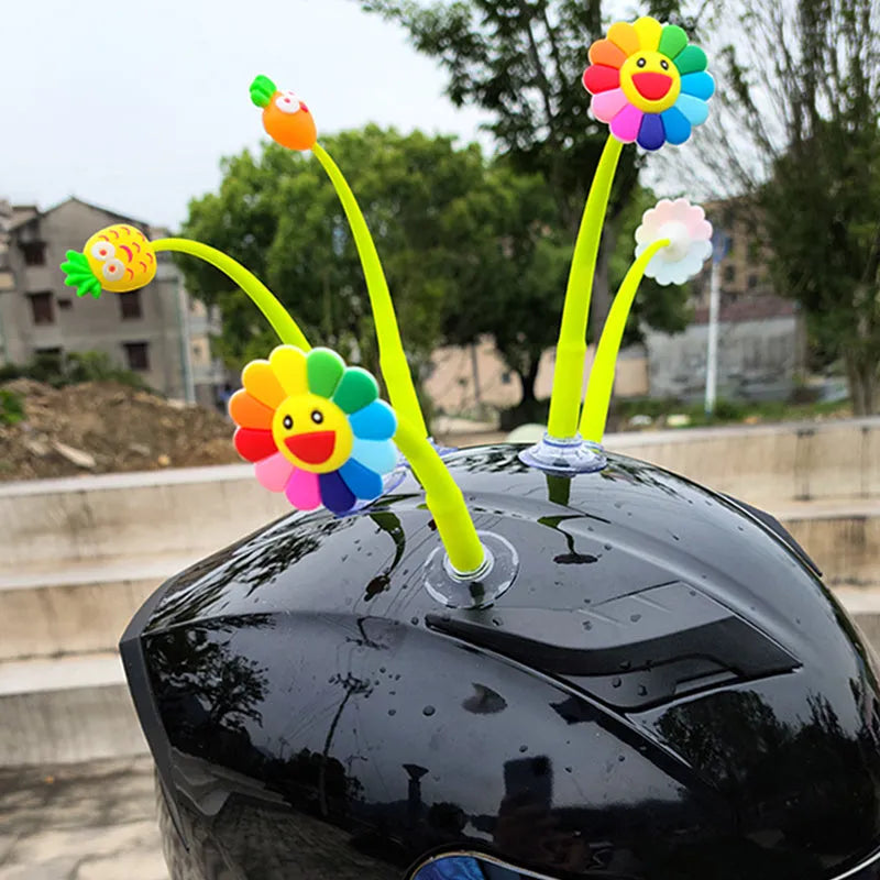 Yellow silicone sunflower helmet decoration with suction cup on a motorbike helmet.