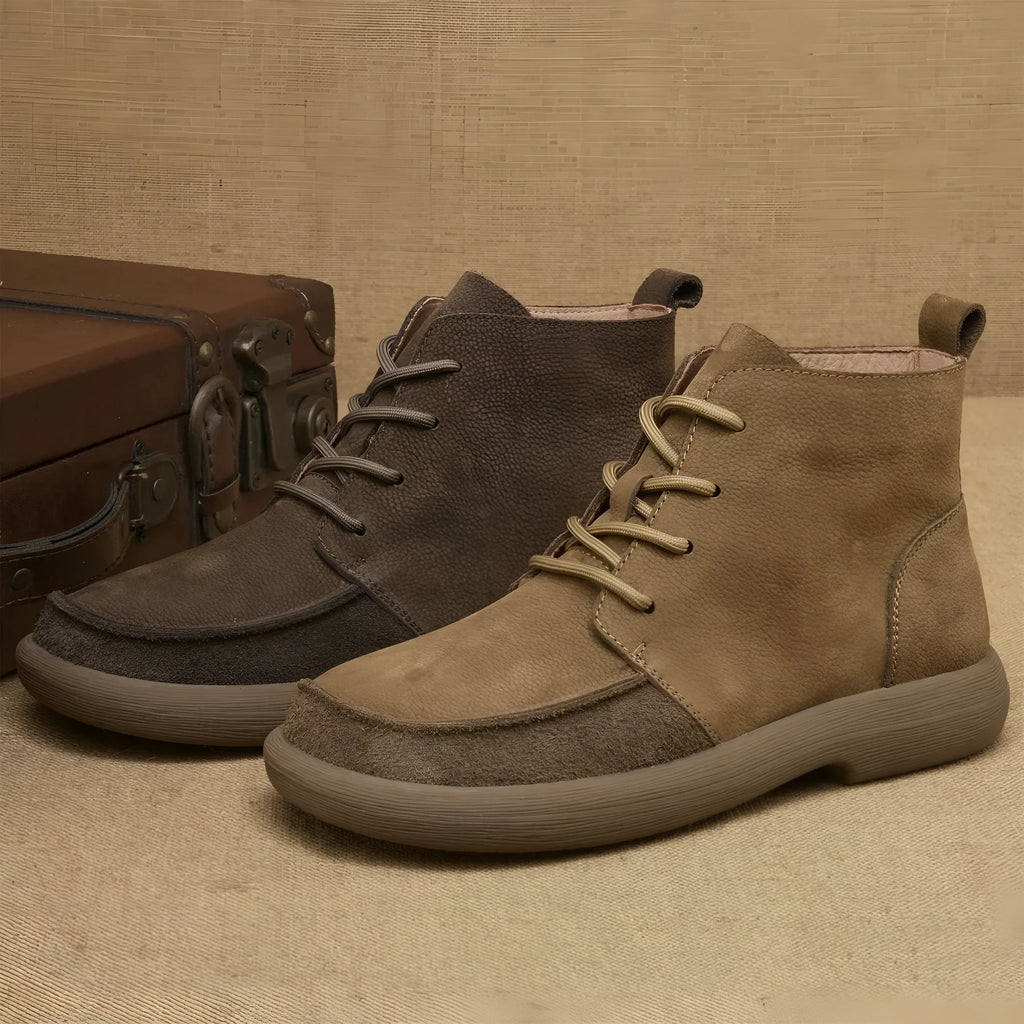 Grey genuine leather Martin boots with wedge heel and front lace-up design on a neutral background.