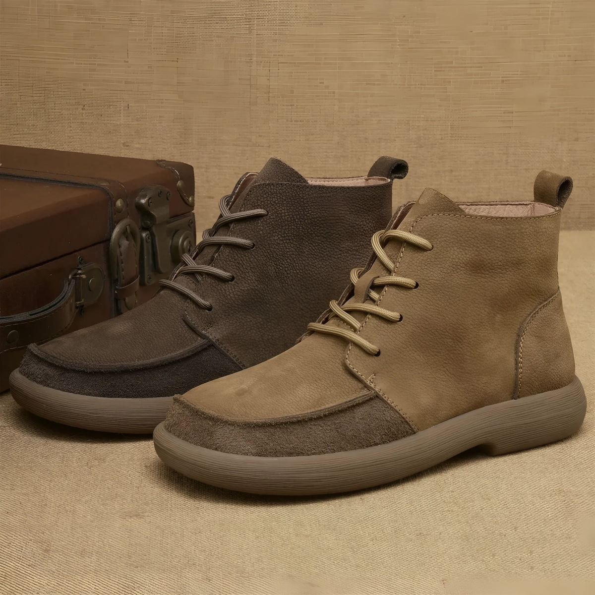 Grey genuine leather Martin boots with wedge heel and front lace-up design on a neutral background.