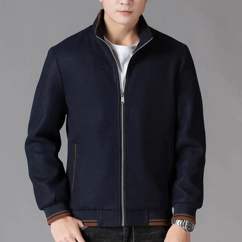 Man wearing a grey fleece sports jacket with a stick pocket on the chest.