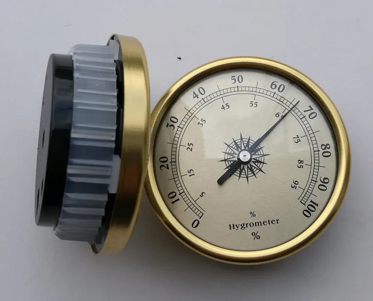 Circular aluminium analogue thermometer and hygrometer showing humidity and temperature dials