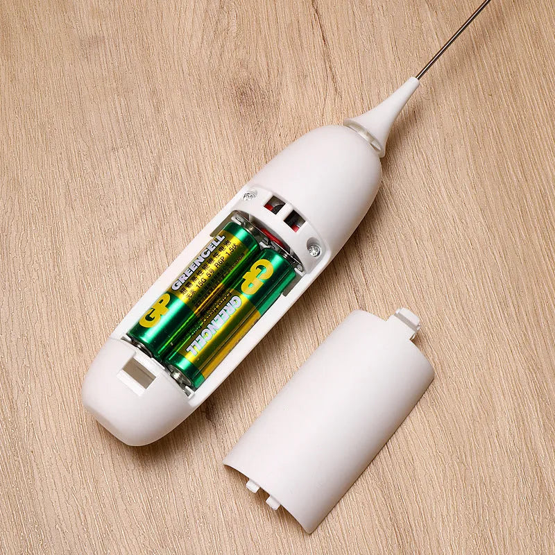 Black and white handheld electric milk frother with whisk attachment for coffee drinks