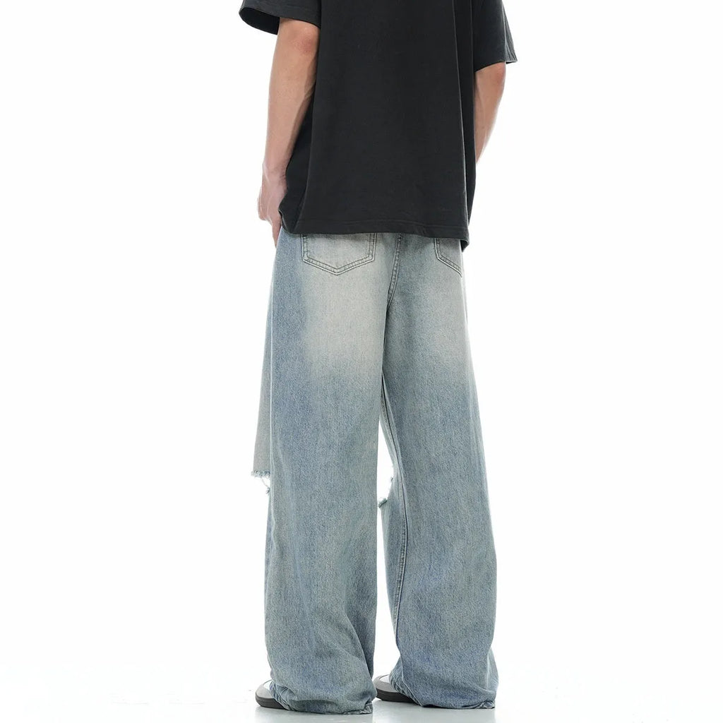 Men's blue straight-leg jeans with retro ripped distressing on the legs