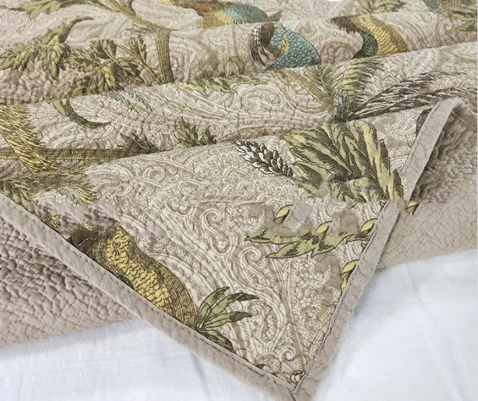 Blue American flower and bird pattern quilted cotton bedspread set on a bed