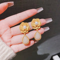 Gold colour Hong Kong style flower stud earrings with opal stones and ice flower design on alloy electroplated construction