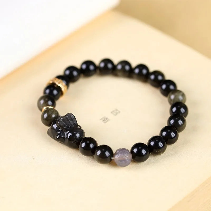 Handmade lying rabbit charm obsidian bracelet with grey agate beads in 8mm and 10mm sizes.