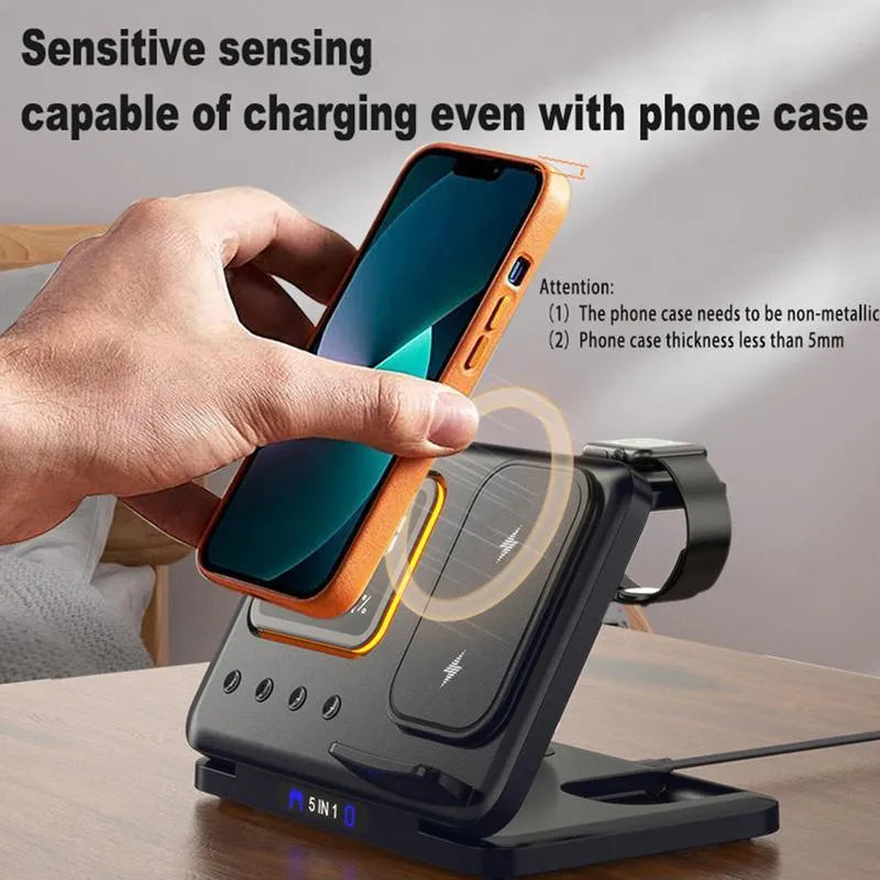Black foldable wireless charging station displaying time and temperature, charging a phone and smartwatch.