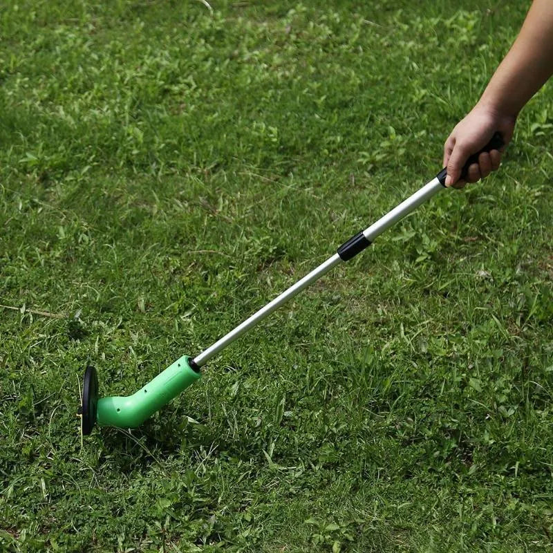 Cordless electric lawn trimmer with extension pole and black debris shield on a green lawn.