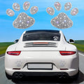Diamond-encrusted bear paw and butterfly car sticker on vehicle surface