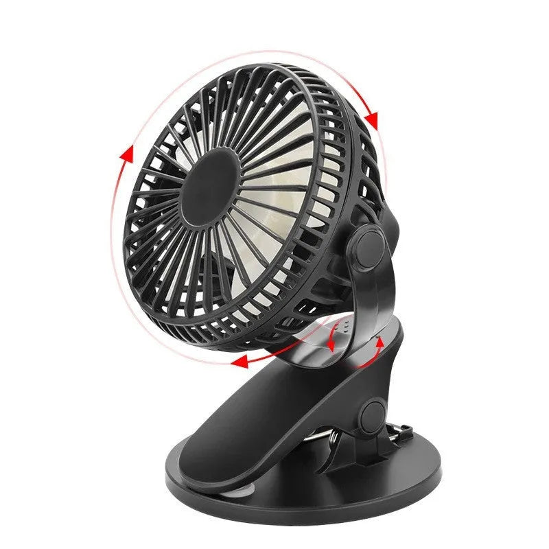 White clip fan with plastic blades attached to desk edge