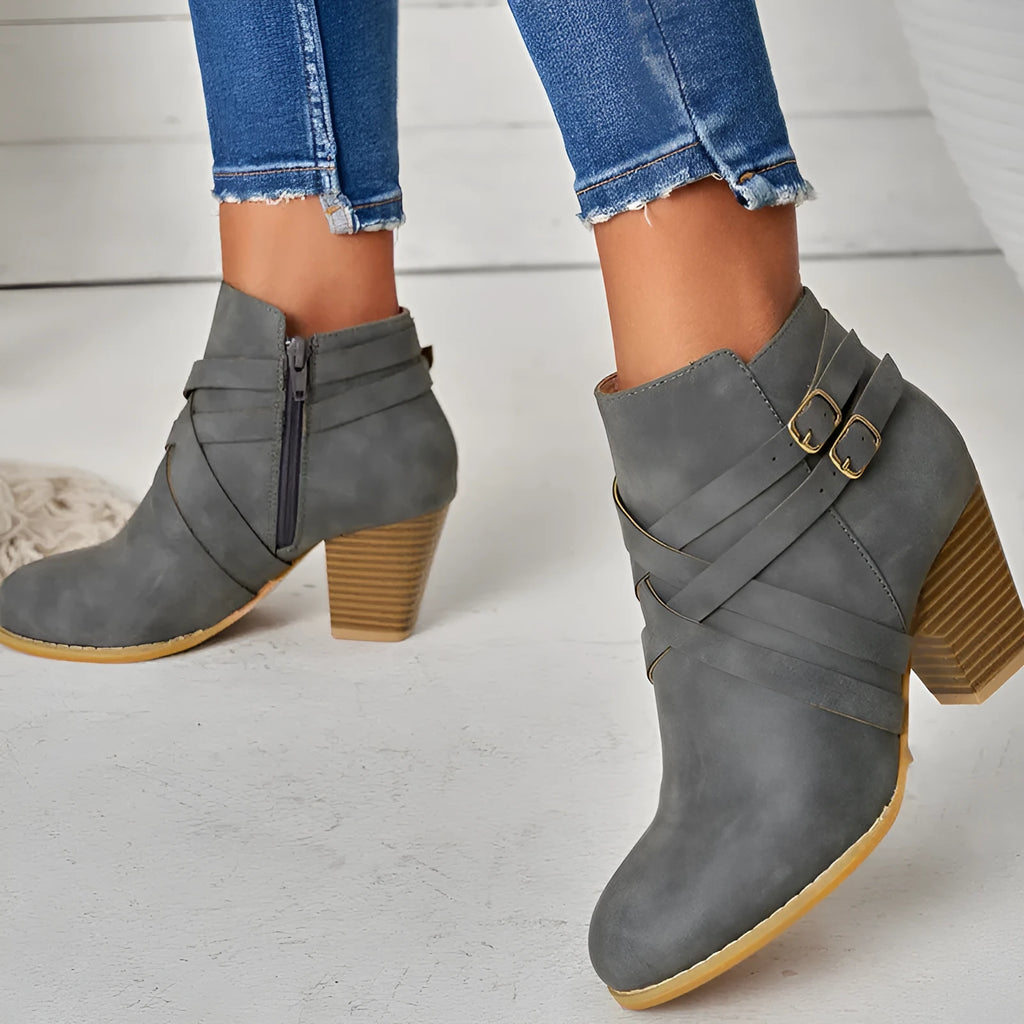 Plus size women's short ankle boots with a 7cm block heel, side zipper, and belt buckle detail in black.