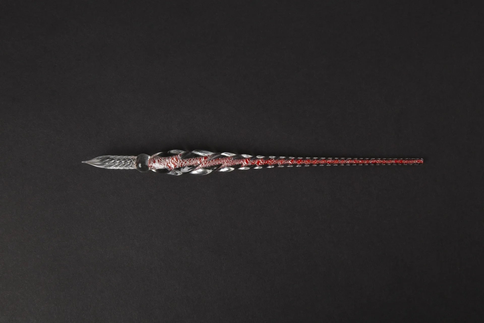 Transparent glass crystal pen with coloured ink visible inside, abstract modelling design