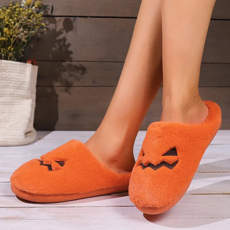 Orange Halloween pumpkin design plush slippers with a non-slip sole.