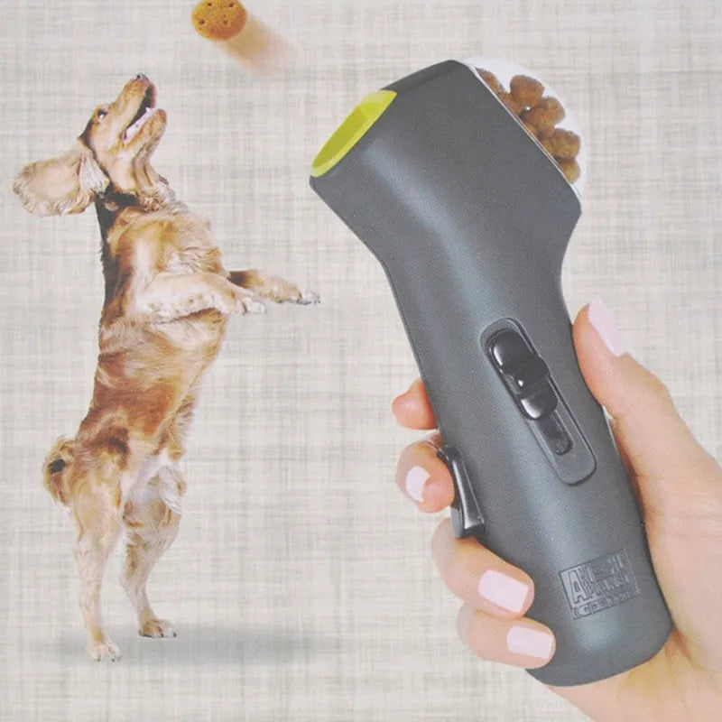 Grey pet snack catapult launcher for dogs and cats, showing compact size and trigger mechanism.