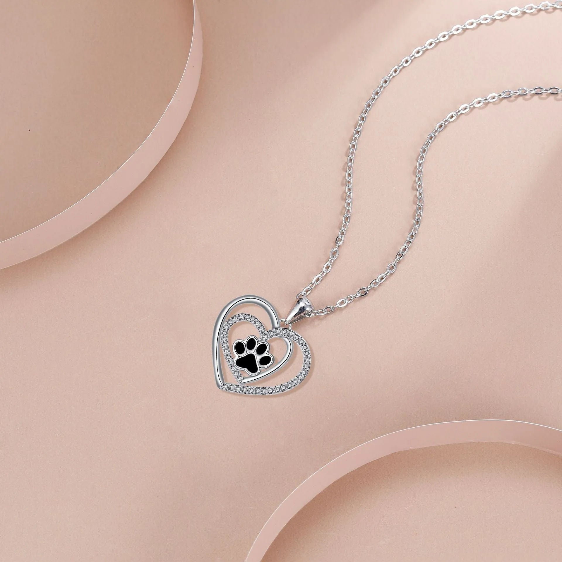 Women's dog paw footprint necklace with heart design on copper pendant and cross chain