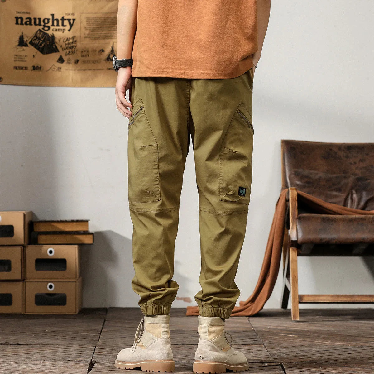 Men's khaki coloured loose-fit tapered harem pants with a small ankle band and elasticated waist.