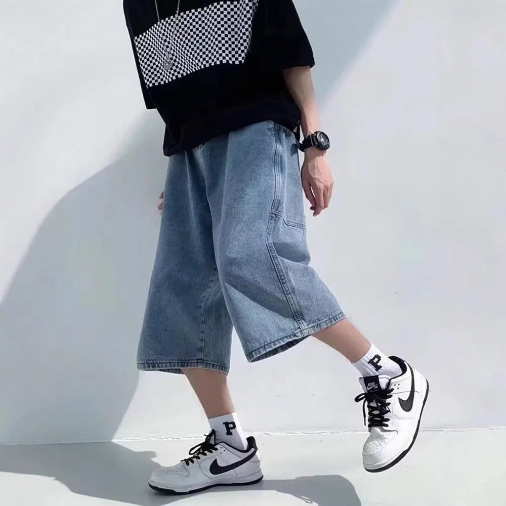 Blue men's washed denim pirate shorts with a high waist and cropped length on a hanger.