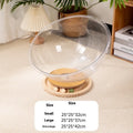 Transparent acrylic capsule cat bed with turntable base on wooden floor