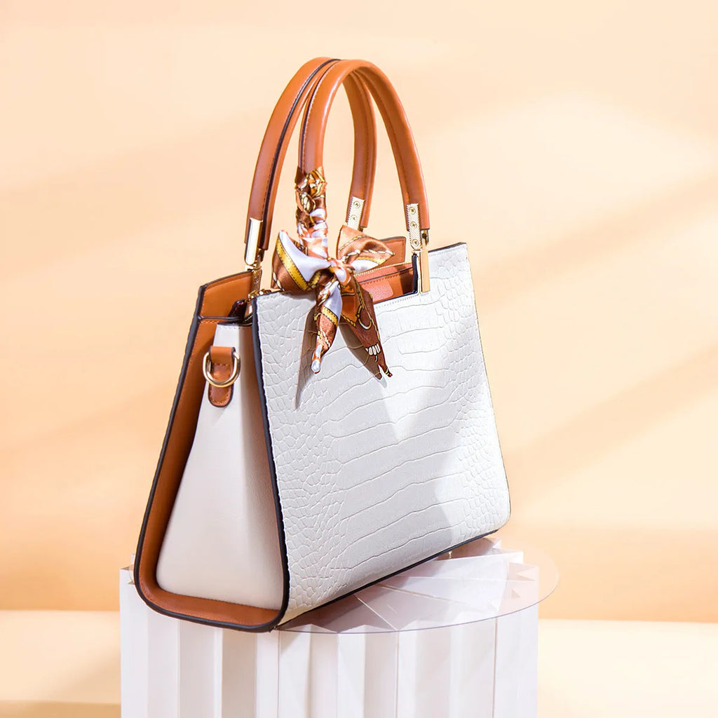 Milky white women's PU leather shoulder handbag with interior organisation pockets in horizontal square shape.