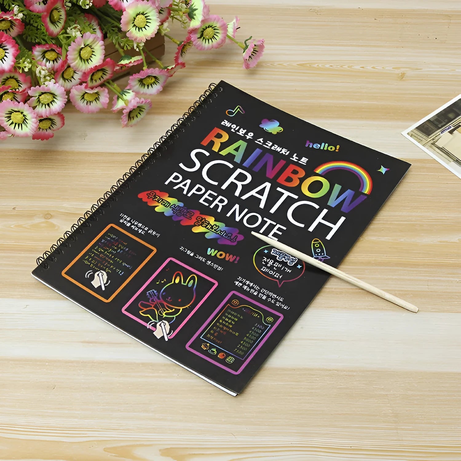 Large colourful children's scratch art paper measuring 26 by 19 centimetres with scraping tool.