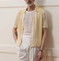 Yellow asymmetric casual polo shirt with hollow-out detail and short sleeves, made from Tencel fabric.