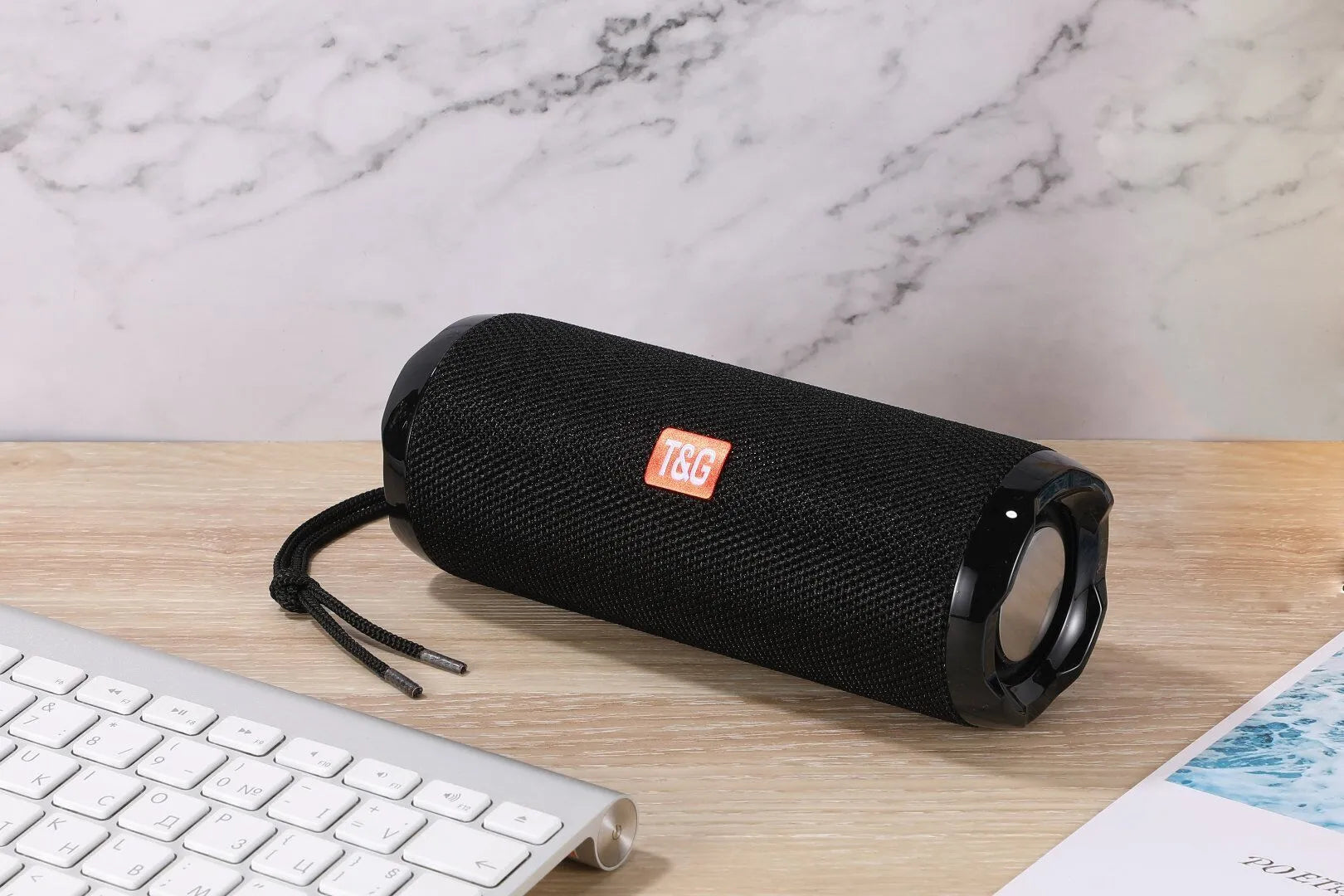 Fabric portable Bluetooth speaker with integrated card holder shown in multiple colour options.