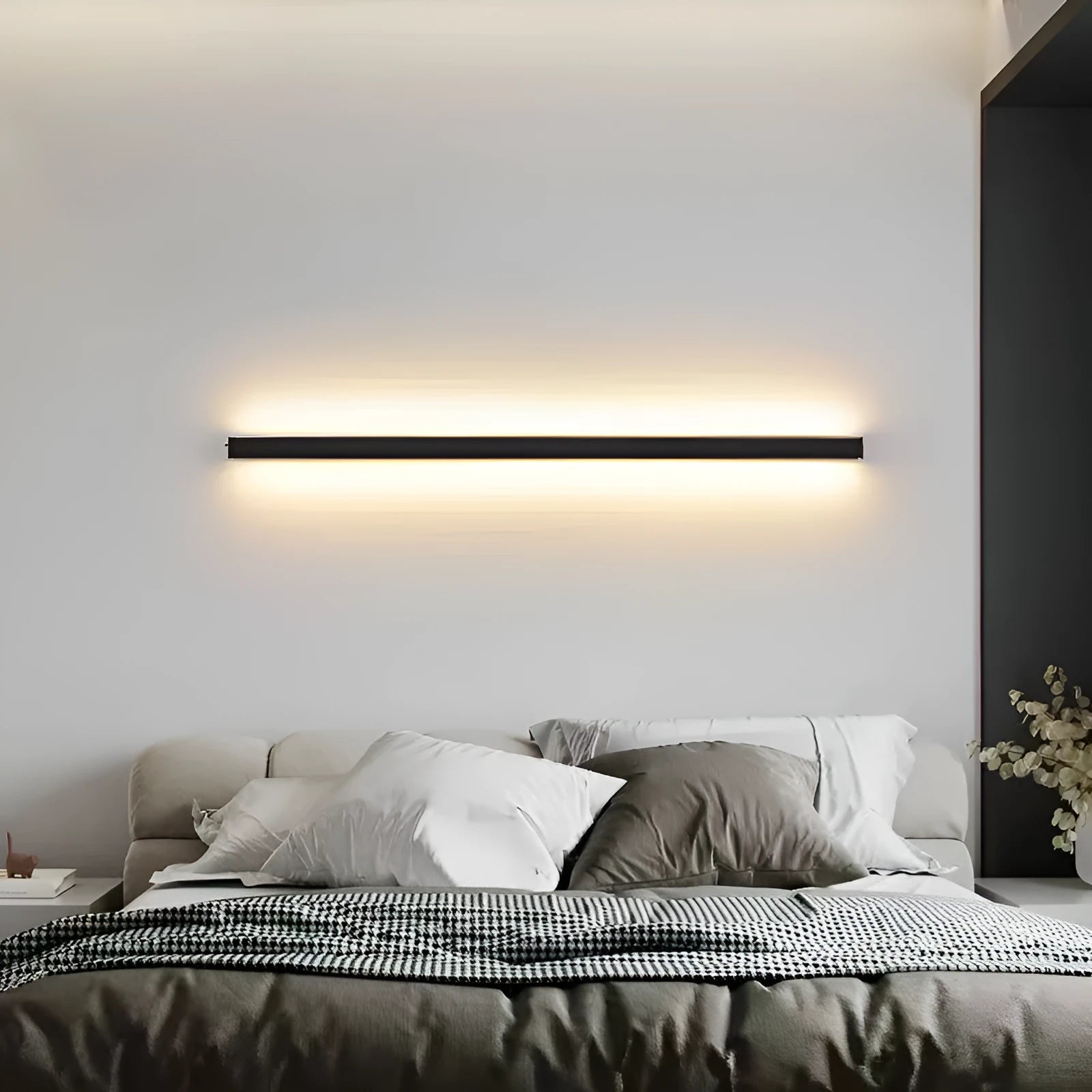 80cm long black aluminium LED strip wall lamp mounted on a wall, showing its simple linear design.