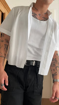 White men's cropped short sleeve polyester shirt on hanger showing regular fit and plain design