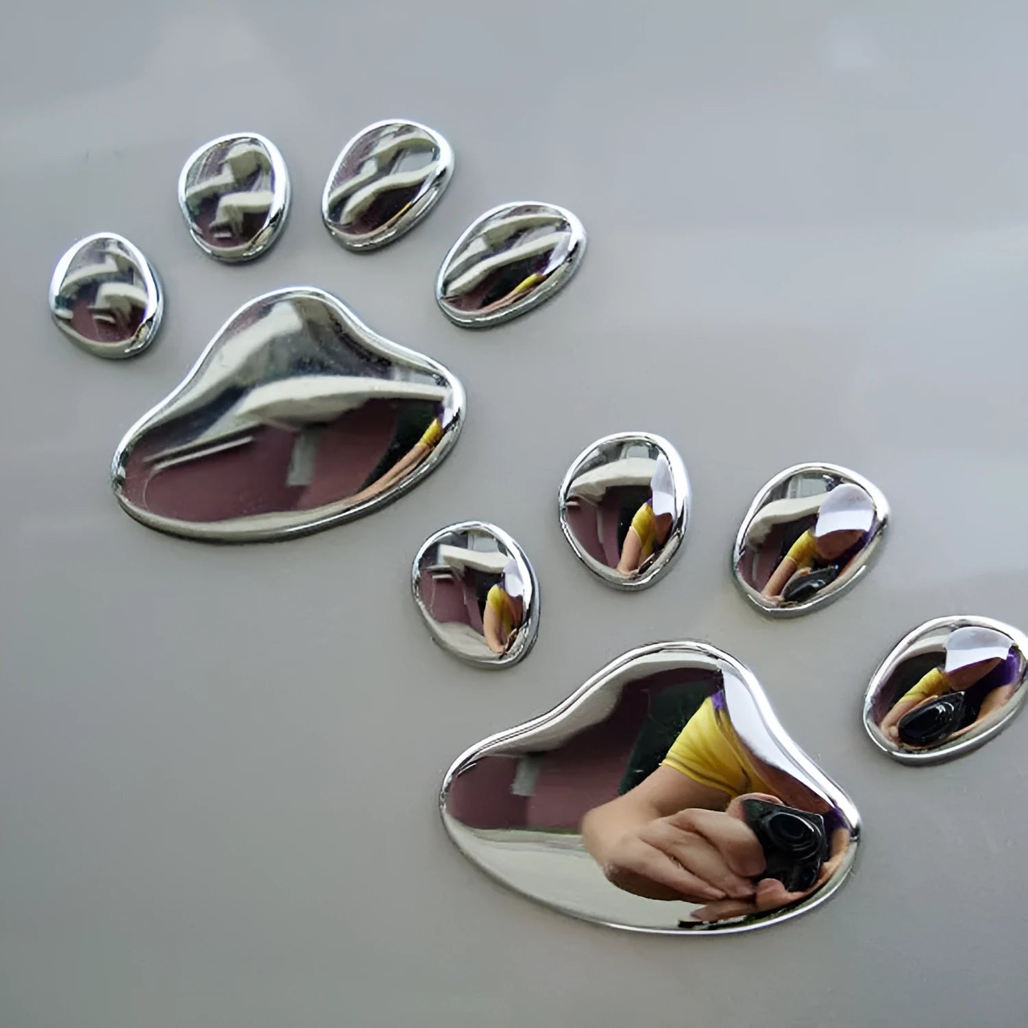PVC dog footprint car sticker in black, gold, red, and silver colour options, measuring 7cm.