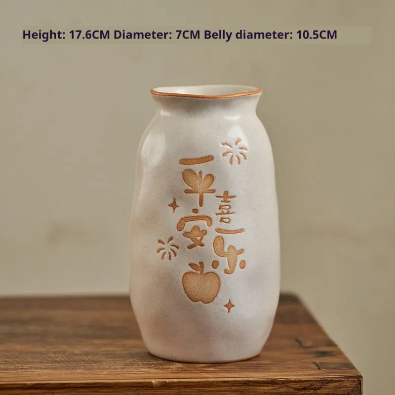 Chinese hand-painted ceramic vase with carved design on wooden desktop
