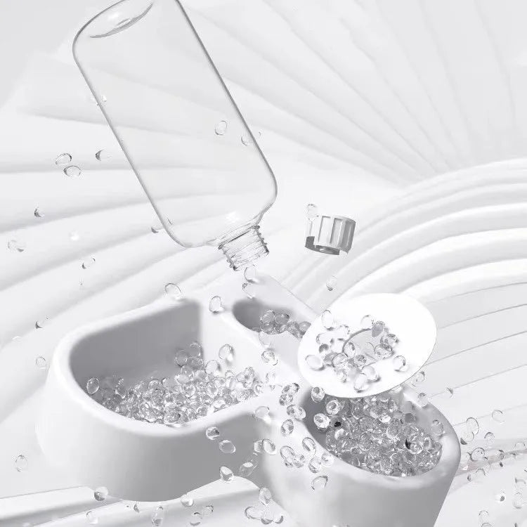 White automatic pet water fountain for cats and dogs on a floor.