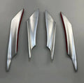 Set of four carbon fibre pattern automotive bumper blades mounted on vehicle