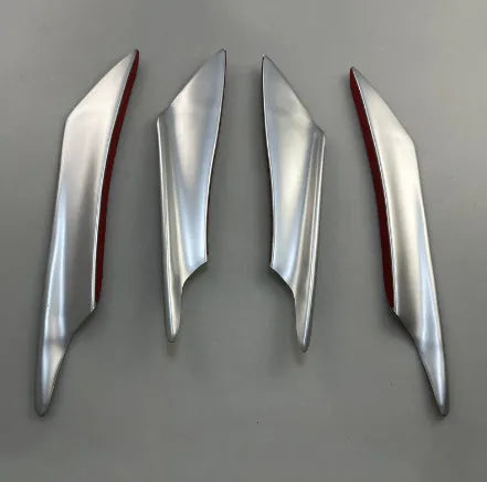 Set of four carbon fibre pattern automotive bumper blades mounted on vehicle