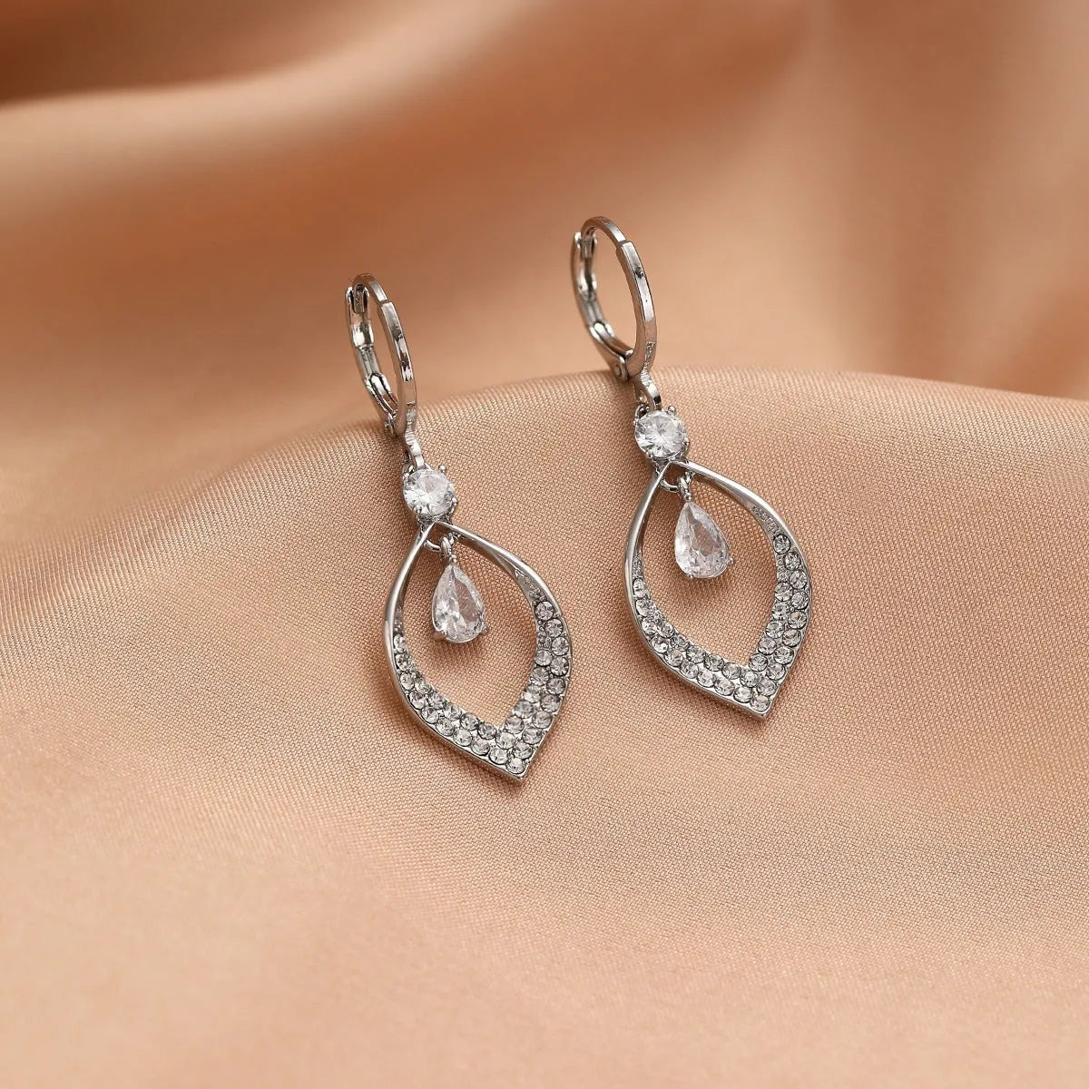 A pair of teardrop-shaped zircon water drop tassel earrings with gold-coloured buckles.