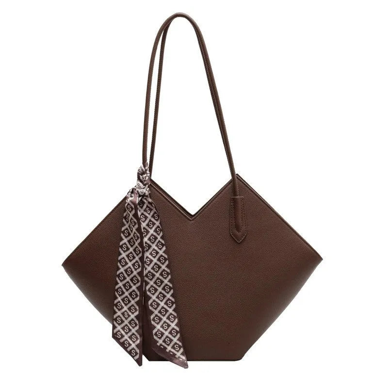 Women's large black PU leather shoulder bag with square shape showing exterior pocket and adjustable handle