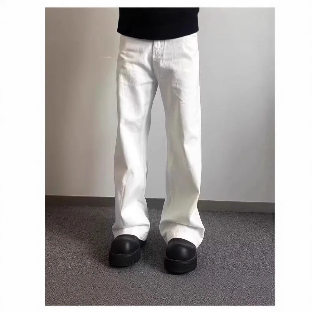 White men's straight-leg jeans with a wide loose cut on a mid waist, featuring a zipper fly.