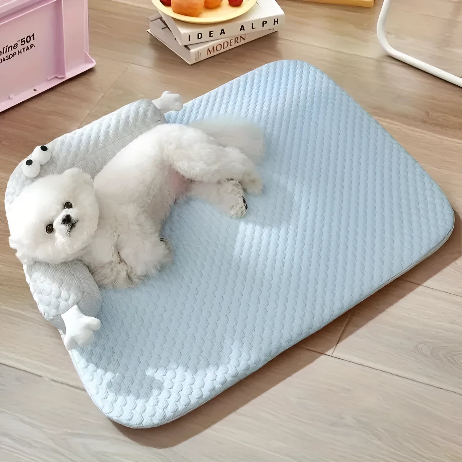 Blue monster design polyester pet bed for dogs and cats on a wooden floor.