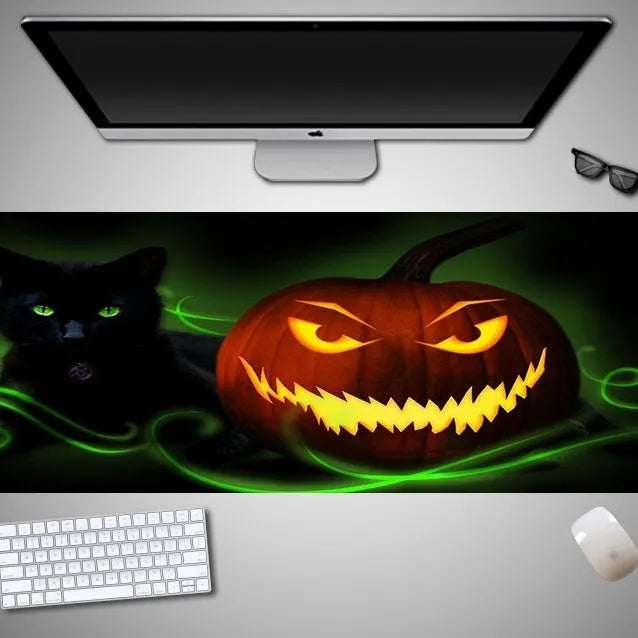 Oversized Halloween-themed rubber cloth mouse pad with non-slip base on a desk.