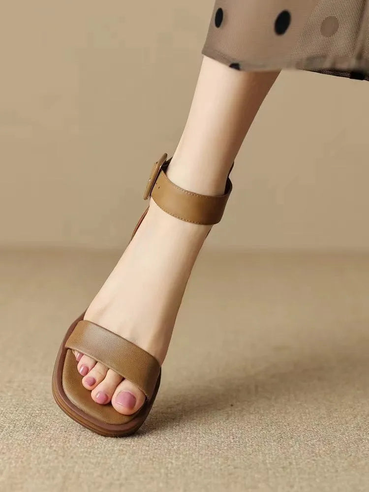Women's white retro ankle-strap platform high heels with round toe and adjustable buckle.