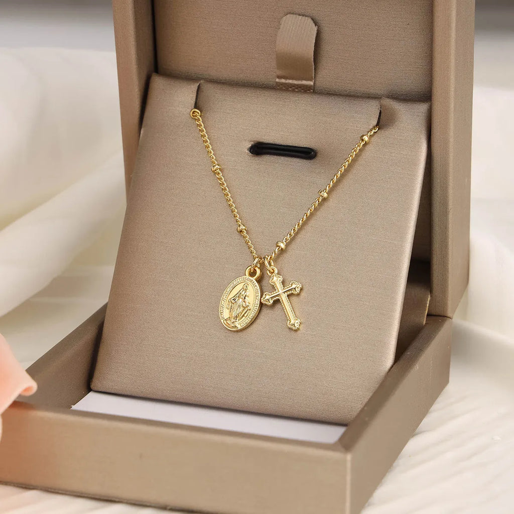 Gold geometric cross Virgin Mary necklace for women on a chain.