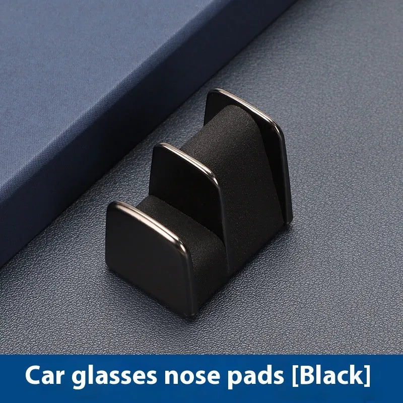 Zinc alloy and leather sunglasses clip holder for car dashboard in black, grey, green, or red.