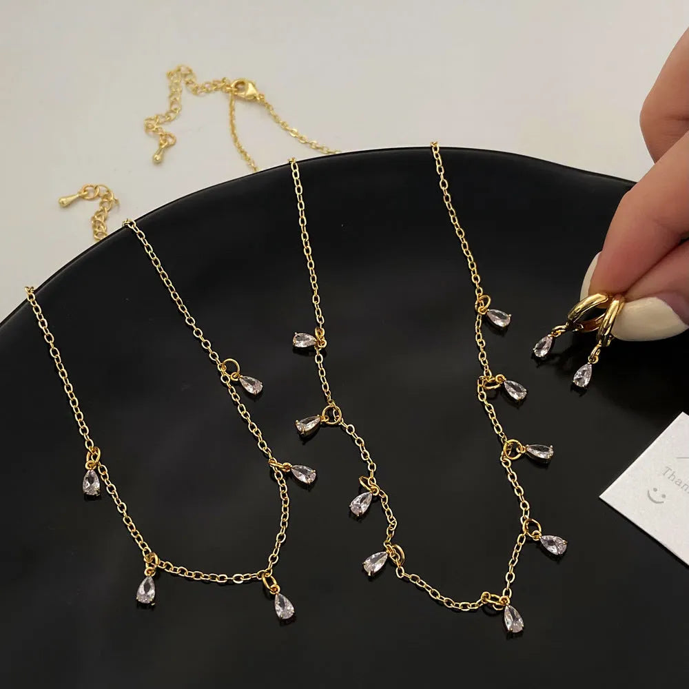 Women's zircon jewellery set with geometric pendant necklace, matching earrings, and anklet