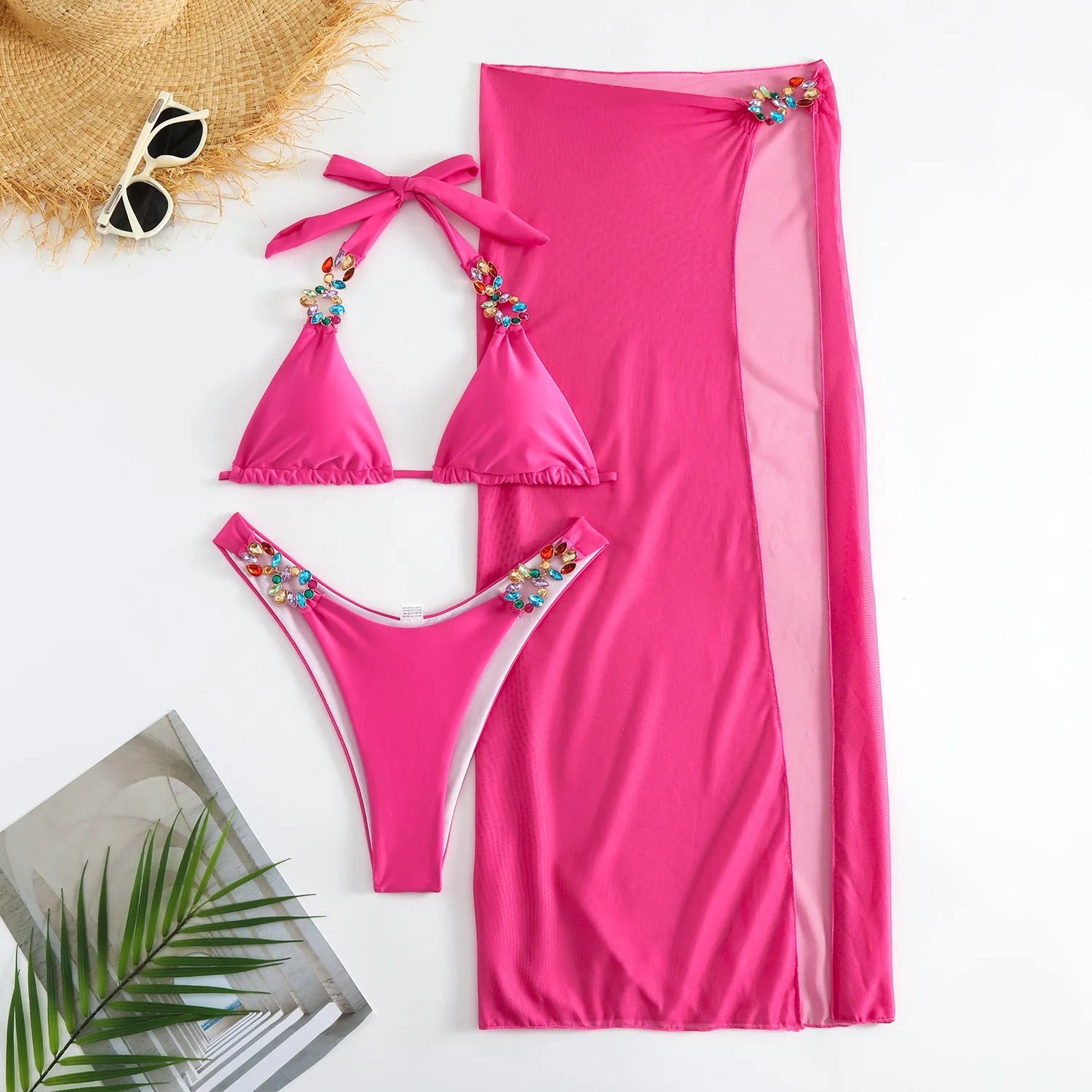 Rose red and yellow three-piece swimsuit bikini set with a mesh skirt laid flat.