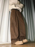 Men's loose pleated straight trousers in black, brown and apricot striped patterns.